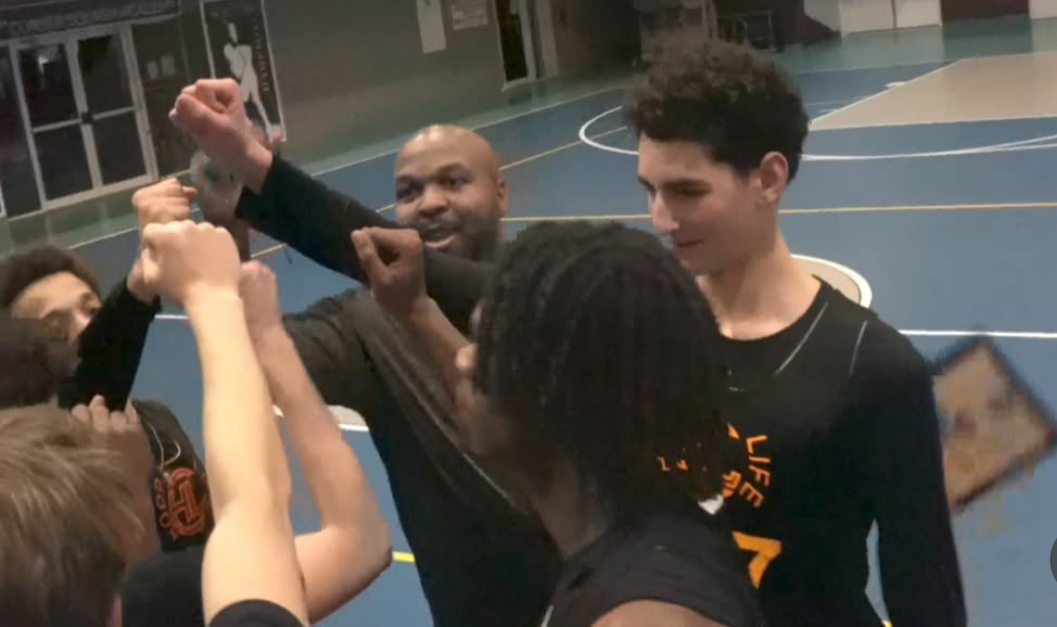 Dashawn Parker in a team huddle
